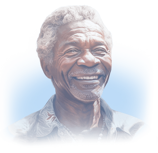 Senior African American man in a Hawaiian button up shirt and shell necklace smiling widely.