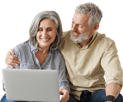 Senior couple with man putting his arms around the woman's shoulder, smiling at a laptop screen.