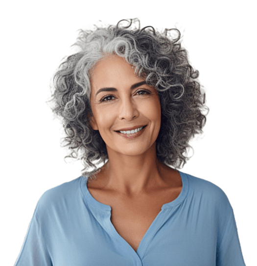 A smiling woman with grey curly hair wearing a blue shirt.
