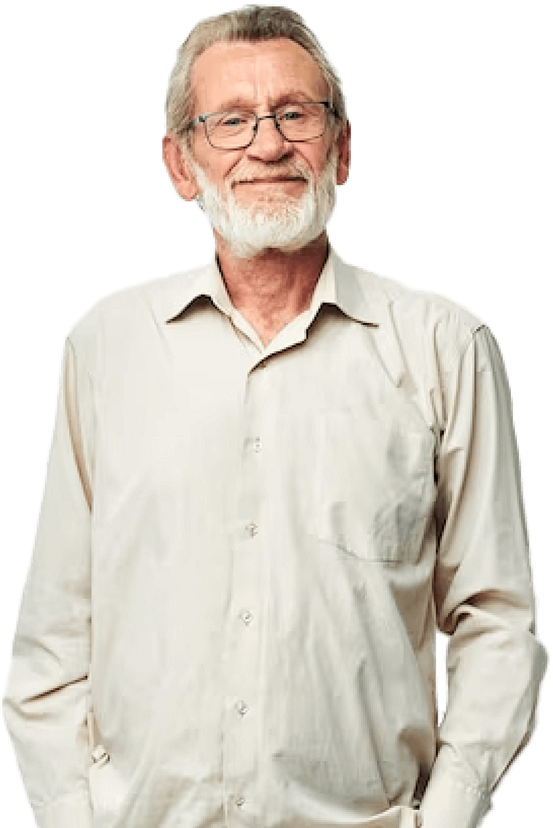 Elderly man with glasses and beard smiling.