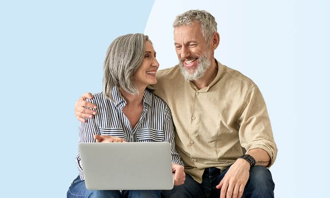 A happy senior couple on a laptop shopping for medicare plans on Healthpilot.